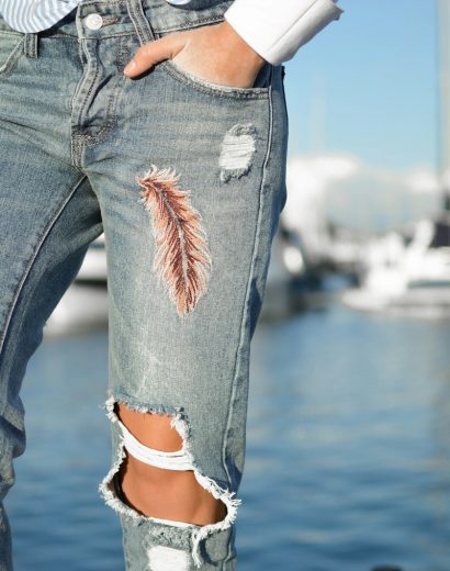 person in gray distressed pants