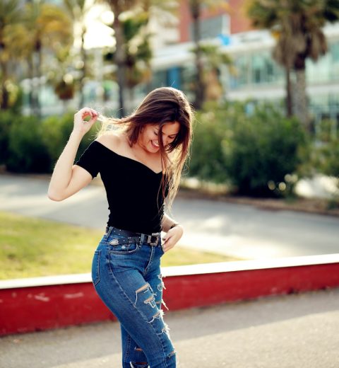 selective focus photography of woman standing near trees